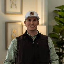 Cameron Caldwell inside a ranch in Burnet Texas posing for his profile picture at Texas Ranch Brokers where he is an agent