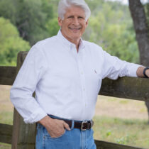 profile picture of Dave Willard standing at fence on a ranch for a profile picture for Texas Ranch Brokers in Burnet County Texas