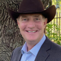 profile picture of Patrick Boykin on a ranch by an oak tree in a cowboy hat in Burnet County Texas for Texas Ranch Brokers